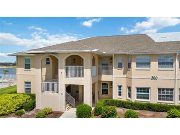 Charming condo exterior with balcony, neutral colors, and lush landscaping at 5800 Sabal Trace Dr # 301, North Port, FL 34287