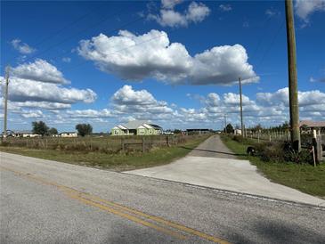 Sprawling country home features a lush green lawn and ample space with a long driveway at 7735 Wauchula Rd, Myakka City, FL 34251