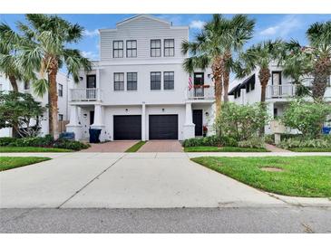 Charming three-story home with palm trees, two-car garage, and well-maintained landscaping at 111 S Packwood Ave # A, Tampa, FL 33606