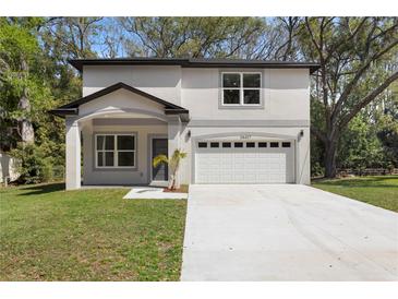 Charming two-story home with a well-manicured lawn and a spacious two-car garage at 16417 Lake Byrd Dr, Tampa, FL 33618