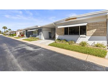 Charming exterior view of single-story homes with covered parking at 250 Nw Rosery Rd # 314, Largo, FL 33770