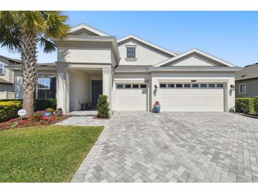 Beautiful two-story home featuring a three-car garage and lovely landscaping at 8766 Shadyside Ln, Land O Lakes, FL 34637