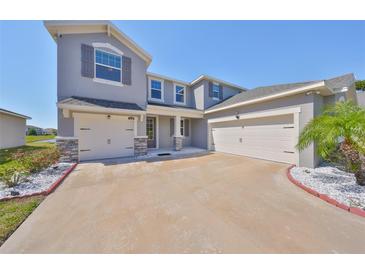 Stunning two-story home with a three car garage and a beautifully landscaped yard at 10708 Planer Picket Dr, Riverview, FL 33569