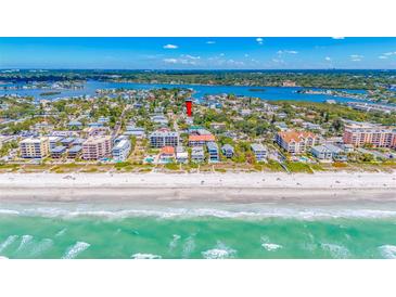 Breathtaking aerial view of a beachfront community with pristine sandy shores and turquoise waters on a sunny day at 119 13Th Ave, Indian Rocks Beach, FL 33785