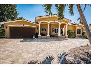 Inviting single-Gathering home featuring a charming facade, meticulously maintained lawn, and a spacious driveway at 1233 Eden Isle Ne Dr, St Petersburg, FL 33704