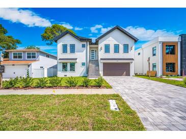 Beautiful two-story home with a well-manicured front lawn and a spacious driveway at 1741 Nevada Ne Ave, St Petersburg, FL 33703