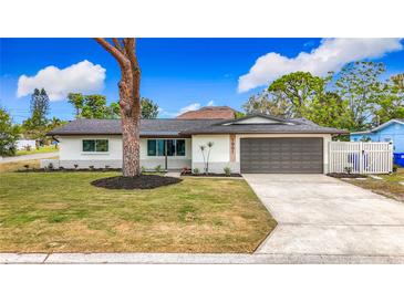 Charming single-story home boasts a manicured lawn, updated facade, and a convenient two-car garage at 1991 67Th S Ave, St Petersburg, FL 33712