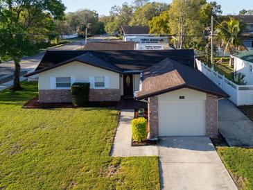 Charming single-story home with a well-manicured lawn and attached one car garage at 3194 Brookview Ave, Largo, FL 33771