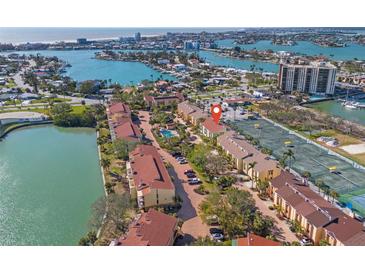 Aerial view showcasing the community with waterfront access, pool, and tennis courts at 442 Sandy Hook Rd, Treasure Island, FL 33706