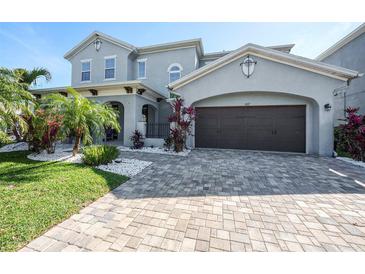 Charming two-story home with a two-car garage and a well-manicured front yard at 6617 Park Strand Dr, Apollo Beach, FL 33572