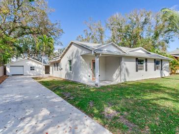 Charming single-story home with a well-maintained lawn and a long private driveway at 2827 W Bay Haven Dr, Tampa, FL 33611