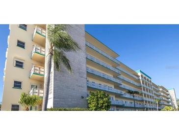 Multi-story condo building with balconies and palm trees in a sunny, tropical setting at 2960 59Th S St # 501, Gulfport, FL 33707