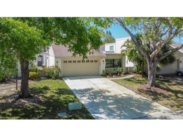 Charming single-Gathering home with a two-car garage and well-manicured lawn at 370 S Woodlands Dr, Oldsmar, FL 34677