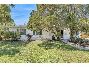 Charming single-story home with lush front yard, mature trees, and a well-maintained exterior at 4227 Porpoise Se Dr, St Petersburg, FL 33705