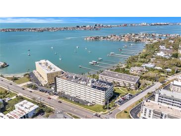 A beautiful aerial view of the condo complex overlooking the ocean with sailboats in the distance at 100 Bluff View Dr # 614A, Belleair Bluffs, FL 33770