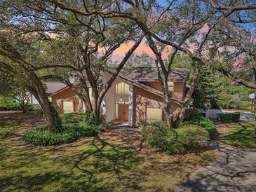 Charming two-story home with landscaped yard and mature shade trees at 2112 Laurence Dr, Clearwater, FL 33764