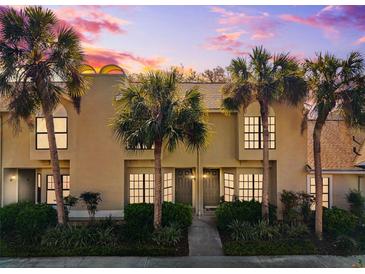 Inviting townhome exterior with palm trees and lush landscaping at sunset at 5100 Burchette Rd # 3403, Tampa, FL 33647