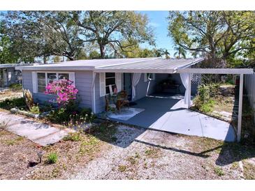 Charming home featuring a covered outdoor seating area perfect for relaxing and enjoying the outdoors at 10128 114Th N Ter, Largo, FL 33773