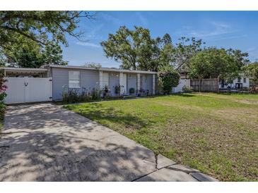 Charming single-story home with a well-manicured lawn, driveway, and landscaping at 1211 E Camellia Dr., Brandon, FL 33510