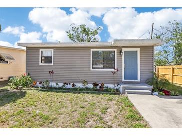 Charming single-story home with light blue door and neutral siding, surrounded by landscaping at 2726 25Th N Ave, St Petersburg, FL 33713