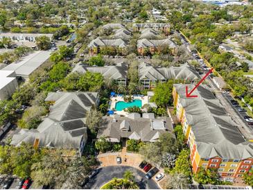 Aerial view showcasing the complex, a refreshing pool, lush landscaping, and convenient parking at 4207 S Dale Mabry Hwy # 2412, Tampa, FL 33611