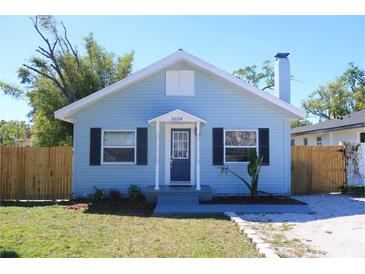 Charming blue bungalow with black shutters, a new yard, and a cute front porch and white trim at 5658 35Th N Way, St Petersburg, FL 33714