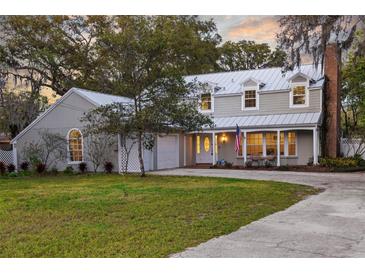 Charming two-story home boasts a well-manicured lawn and covered porch at 614 Vanderbaker Rd, Temple Terrace, FL 33617