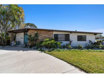 Charming single story home with stone accent, blue door and well maintained front yard at 1600 Delaware Ne Ave, St Petersburg, FL 33703