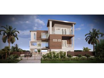 Modern three-story home boasts clean lines, wood accents, glass railings, and tropical landscaping at 575 Crystal Dr, Madeira Beach, FL 33708