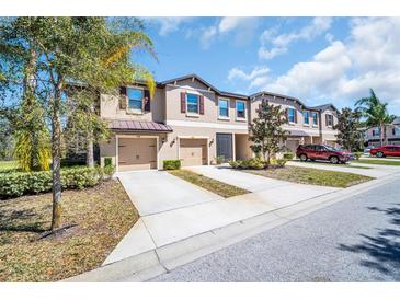 Inviting townhomes featuring attached garages and manicured landscaping at 8512 Reedville St, New Port Richey, FL 34654