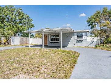 Charming single-story home featuring a covered front porch and a spacious front yard at 10309 108Th Ave, Largo, FL 33773