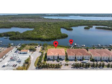 Aerial view of waterfront condos with boat docks and lush green surroundings at 1076 Paseo Del Rio Ne, St Petersburg, FL 33702