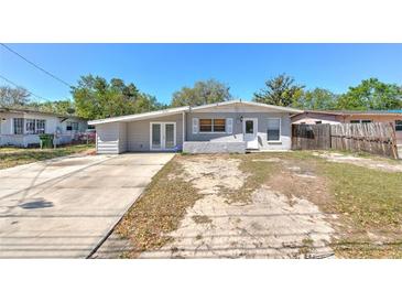 Charming single-story home with a well-maintained front yard and concrete driveway at 10928 N 15Th St, Tampa, FL 33612