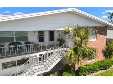 Inviting two-story condo building with brick accents, stair access, and manicured landscaping at 330 Brandy Wine Dr # 330, Largo, FL 33771