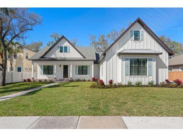 Charming two-story home with a lush green lawn and attractive modern farmhouse details at 0 Old Country Rd, Odessa, FL 33556