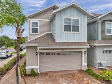 Charming two-story home featuring a brick driveway, a two-car garage, and a freshly landscaped yard at 5728 Skytop Dr, Lithia, FL 33547