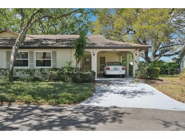 Charming single-story home featuring a covered carport and manicured landscaping at 2009 Halidom Way, Sun City Center, FL 33573