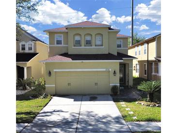 Charming two-story home featuring a well-manicured lawn, two car garage, and inviting curb appeal at 31730 Spoonflower Cir, Wesley Chapel, FL 33545
