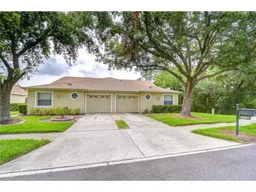 Charming single-story villa with a two-car garage and manicured front lawn at 34907 Double Eagle Ct, Zephyrhills, FL 33541