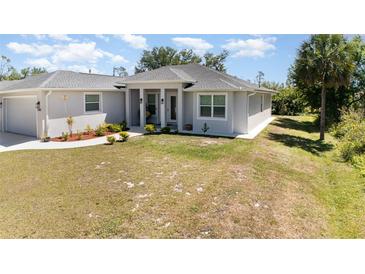 Charming single-story home featuring manicured landscaping and a welcoming front entrance at 2202 Yalta Ter, North Port, FL 34286