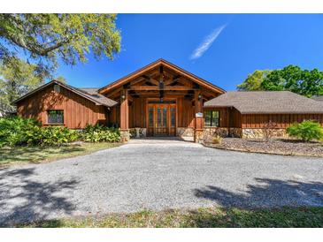 Charming home featuring a wood and stone facade, gravel drive and a statement front door at 27547 Miller Rd, Dade City, FL 33525