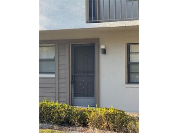 The front of the unit features a secure screen door and updated lighting fixture at 3046 Eastland Blvd # J106, Clearwater, FL 33761