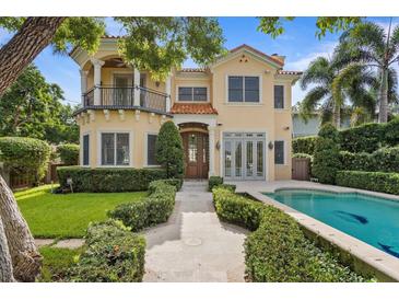 Inviting home with a terracotta roof, manicured landscaping, and a private pool in a desirable location at 608 Orange Ave, Clearwater, FL 33756