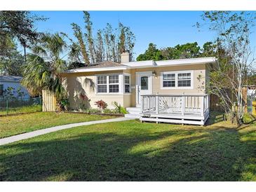 Charming single-story home with a well-manicured lawn, quaint front porch, and lovely curb appeal at 3220 10Th N St, St Petersburg, FL 33704