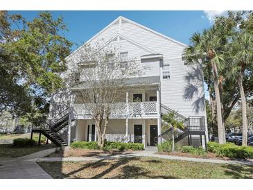 Charming condo complex with well-maintained grounds and inviting staircases, enhanced by lush trees at 3310 Haviland Ct # 202, Palm Harbor, FL 34684