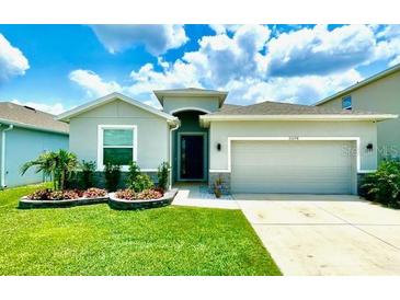 Charming single-story home with well-maintained lawn and manicured landscaping, enhancing its curb appeal at 33298 Major Oak Dr, Wesley Chapel, FL 33545