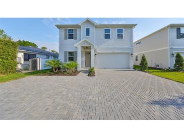 Charming two-story home with landscaped yard and brick paved driveway at 3915 W Euclid Ave, Tampa, FL 33629