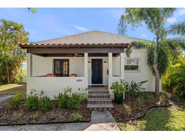 Inviting front porch with stylish seating and a decorative front door at 409 Erie Ave, Tampa, FL 33606