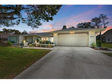 Charming single-story home featuring a well-manicured lawn and attached two-car garage at 5232 Kirkwood Ave, Spring Hill, FL 34608