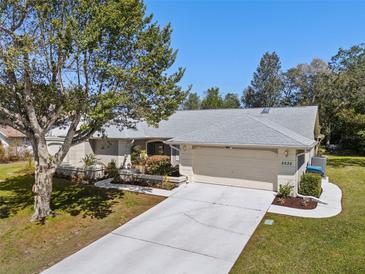 Charming single-story home with a well-maintained lawn, mature trees, and an attached two-car garage at 5232 Kirkwood Ave, Spring Hill, FL 34608